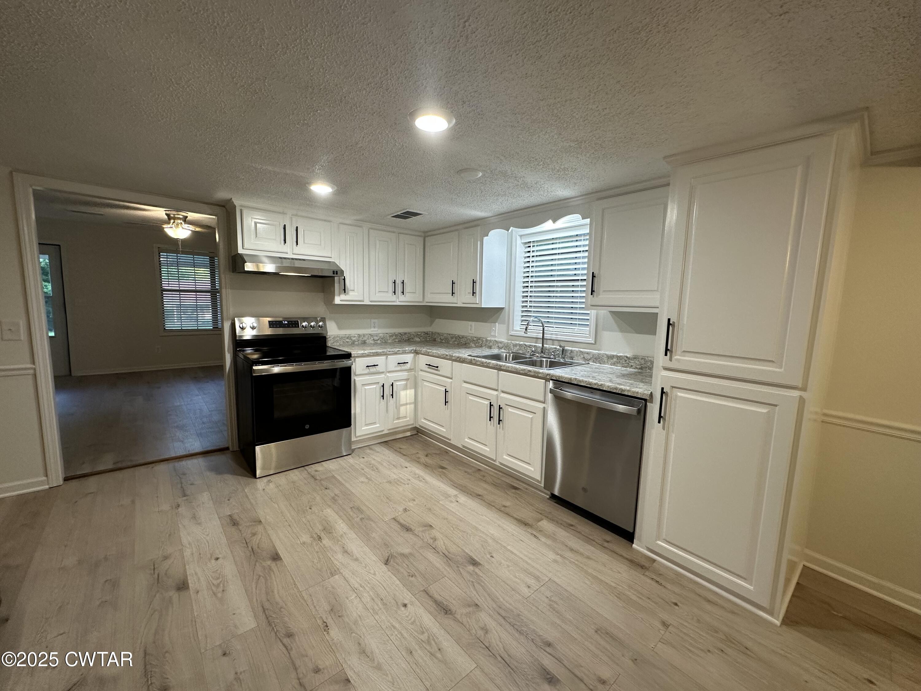 1975 Old Toone Road Medon, TN 38356 - Photo 8 of 21 a kitchen with stainless steel appliances a refrigerator sink and cabinets