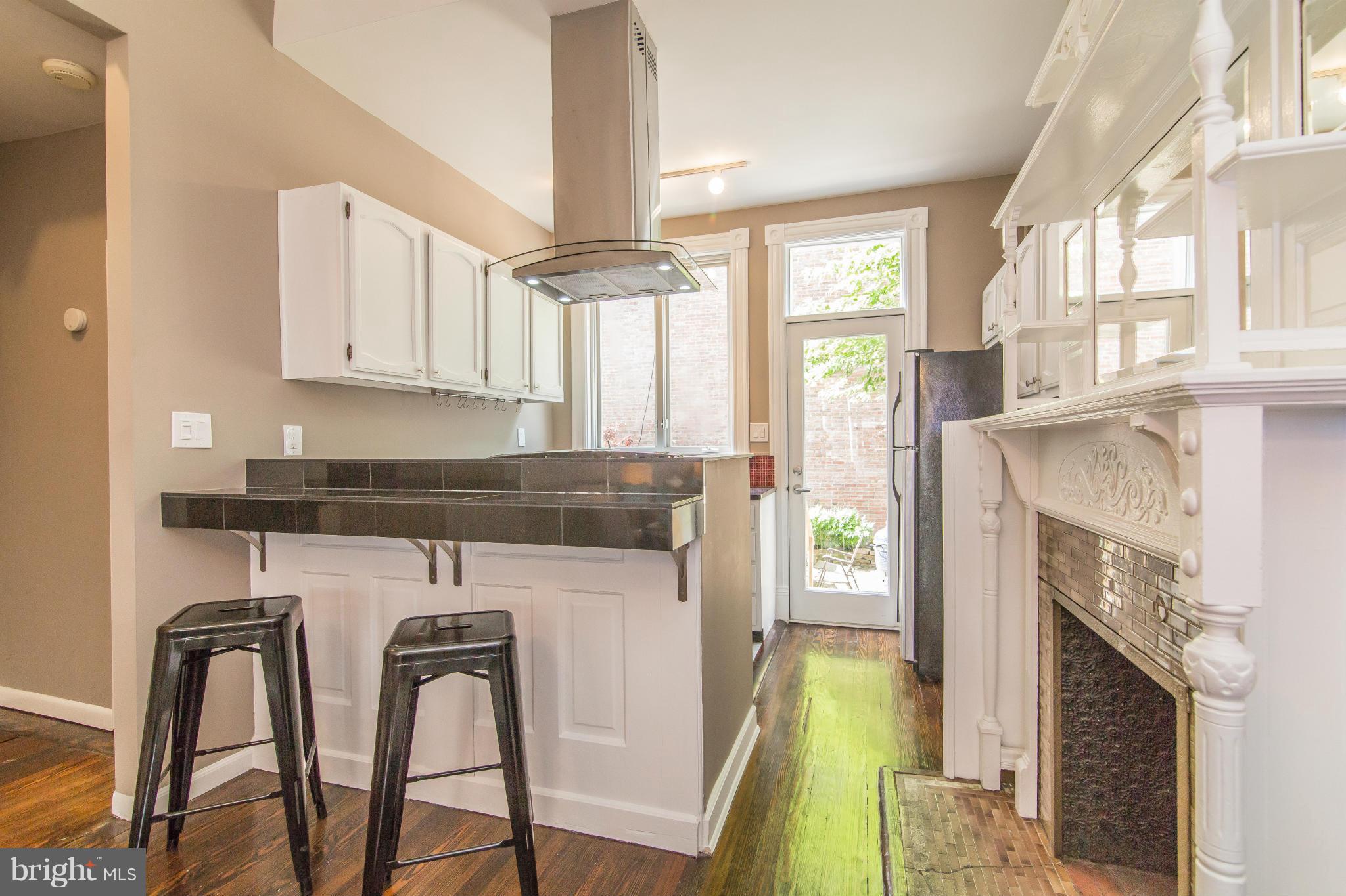 1806 Riggs Place Northwest, Unit 1 Washington, DC 20009 - Photo 7 of 21 Upgraded Kitchen with Breakfast Bar