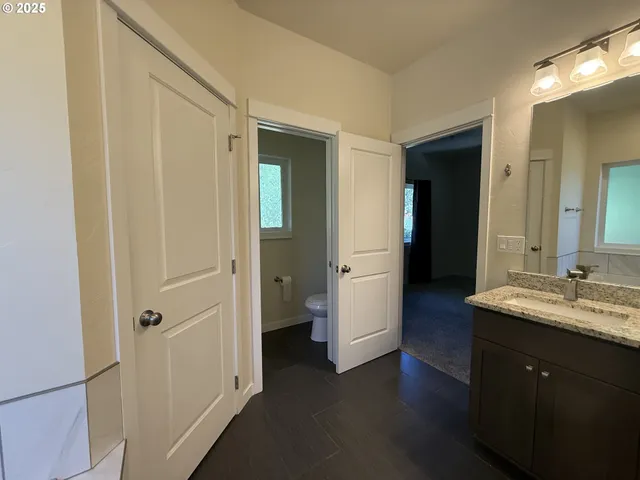a bathroom with a double vanity sink and mirror