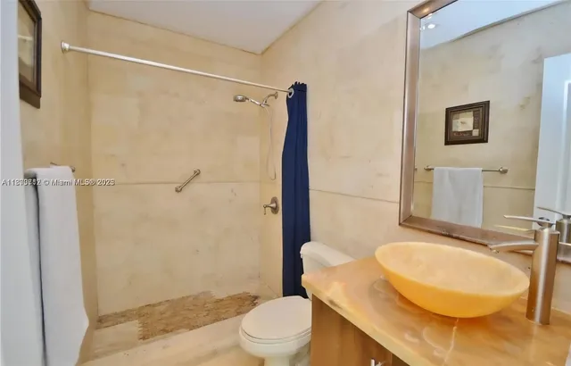 a bathroom with a sink toilet and shower