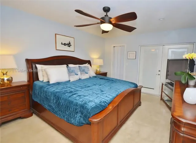 a bedroom with bed and a chandelier