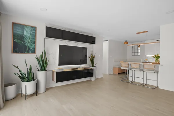 a living room with furniture and a potted plant