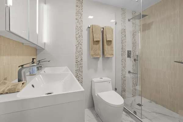 a bathroom with a sink toilet and shower