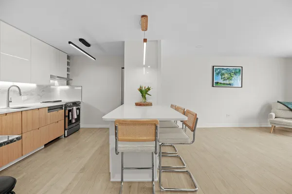 a view of a kitchen with furniture and wooden floor