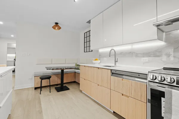 a kitchen with sink cabinets and stove top oven