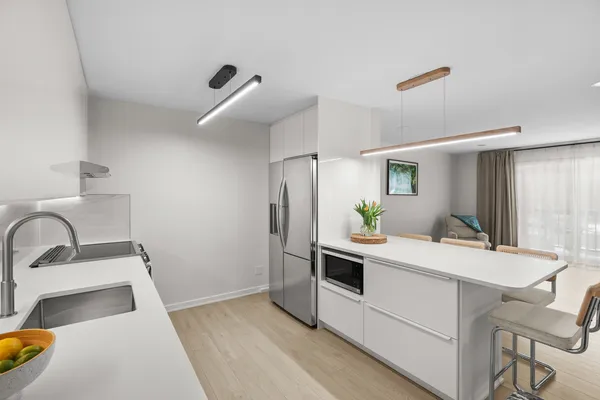 a kitchen with a sink and a refrigerator