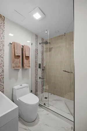 a bathroom with a toilet a sink and shower