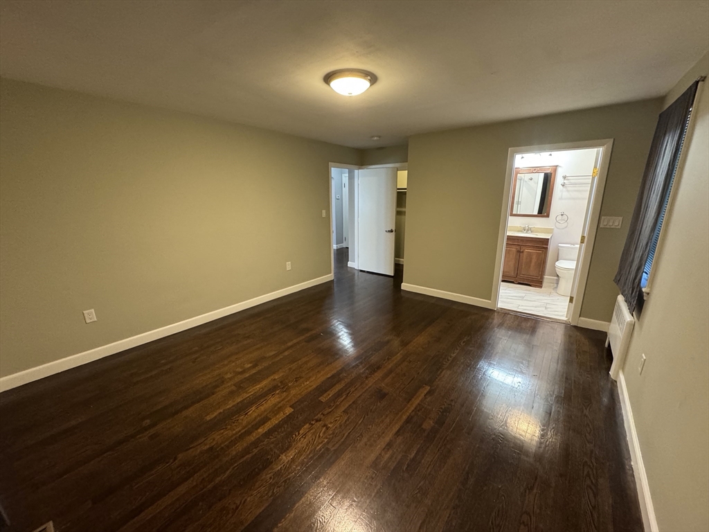 793 Dedham Street Newton, MA 02459 - Photo 19 of 26 a view of an empty room with wooden floor and a window