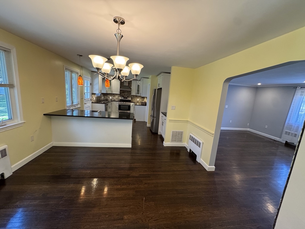 793 Dedham Street Newton, MA 02459 - Photo 22 of 26 a view of a living room a kitchen and a wooden floor