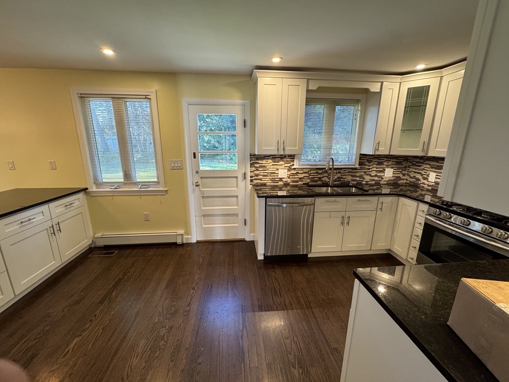 793 Dedham Street Newton, MA 02459 - Photo 6 of 26 a kitchen with stainless steel appliances granite countertop a stove a sink and a refrigerator