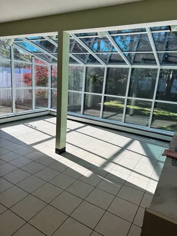 a view of house with a large window and wooden floor