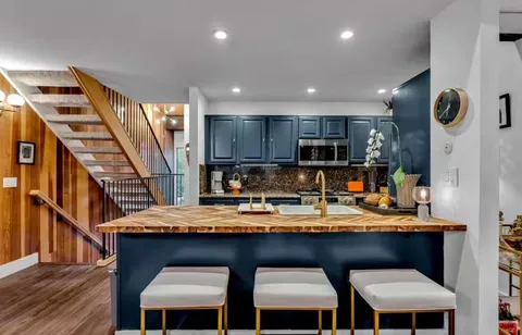 a kitchen with a table chairs refrigerator and microwave