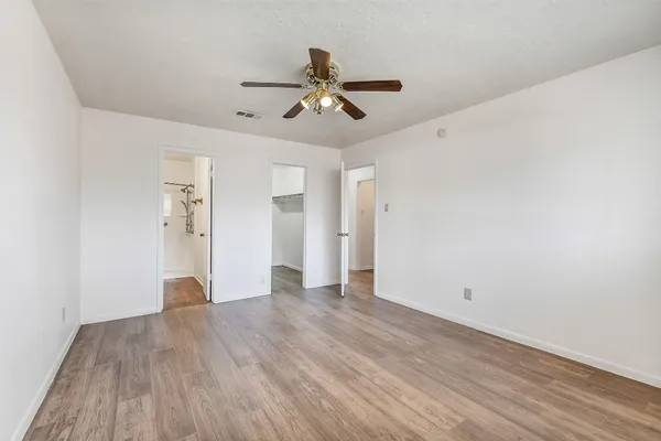 a view of empty room with wooden floor