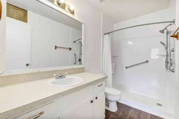 a bathroom with a sink toilet tub and shower