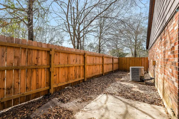 a backyard of a house with wooden fence