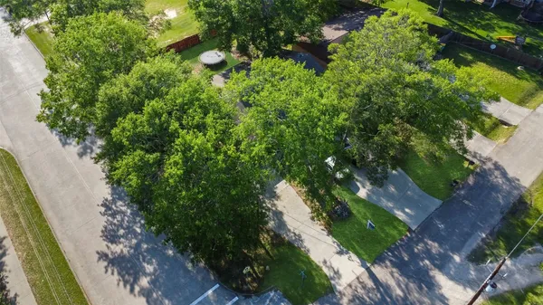 an aerial view of a house with yard