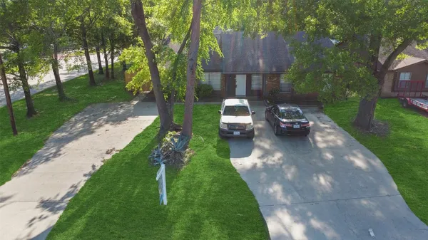 a view of a back yard of the house with a patio