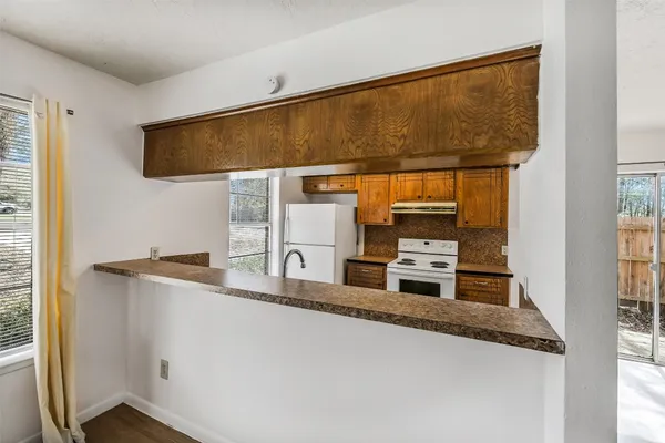 a kitchen with stainless steel appliances granite countertop a sink and a refrigerator