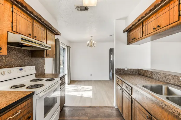 a kitchen with a stove and a sink