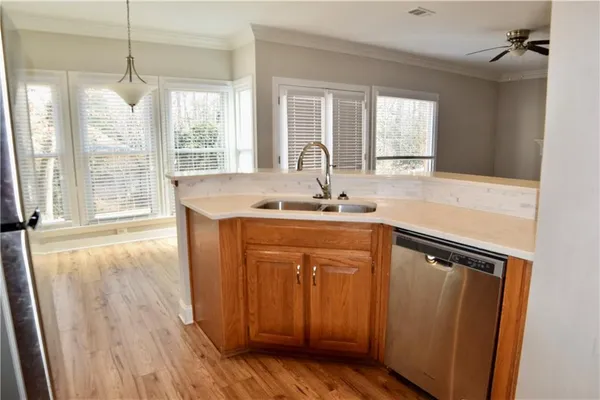 a kitchen with a sink window and cabinets