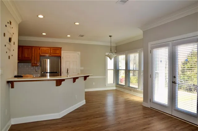 a view of work space with wooden floor and windows
