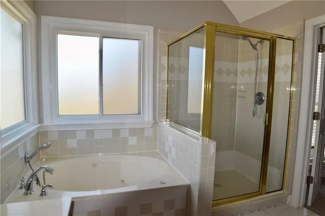 a bathroom with a bathtub and a shower