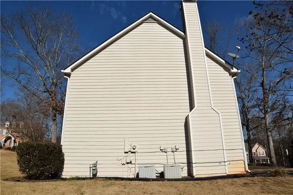 a view of a white house with a yard
