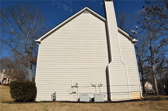 a view of a white house with a yard