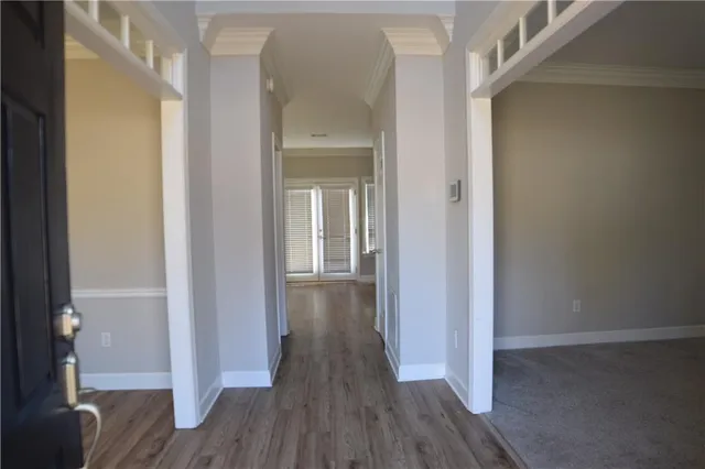 a view of a hallway with wooden floor