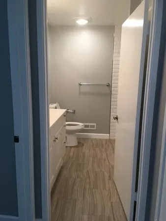a view of a bathroom with wooden floor