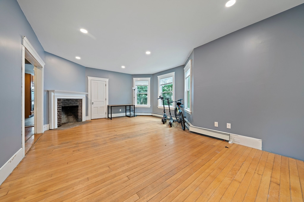 10 Trowbridge Road Worcester, MA 01609 - Photo 11 of 38 a view of an empty room with wooden floor and a fireplace