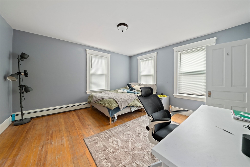 10 Trowbridge Road Worcester, MA 01609 - Photo 14 of 38 a bedroom with a bed and wooden floor