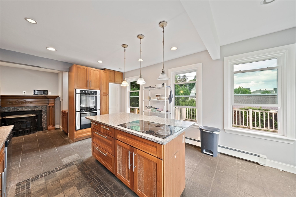 10 Trowbridge Road Worcester, MA 01609 - Photo 5 of 38 a kitchen with stainless steel appliances granite countertop a sink a stove and a wooden floors
