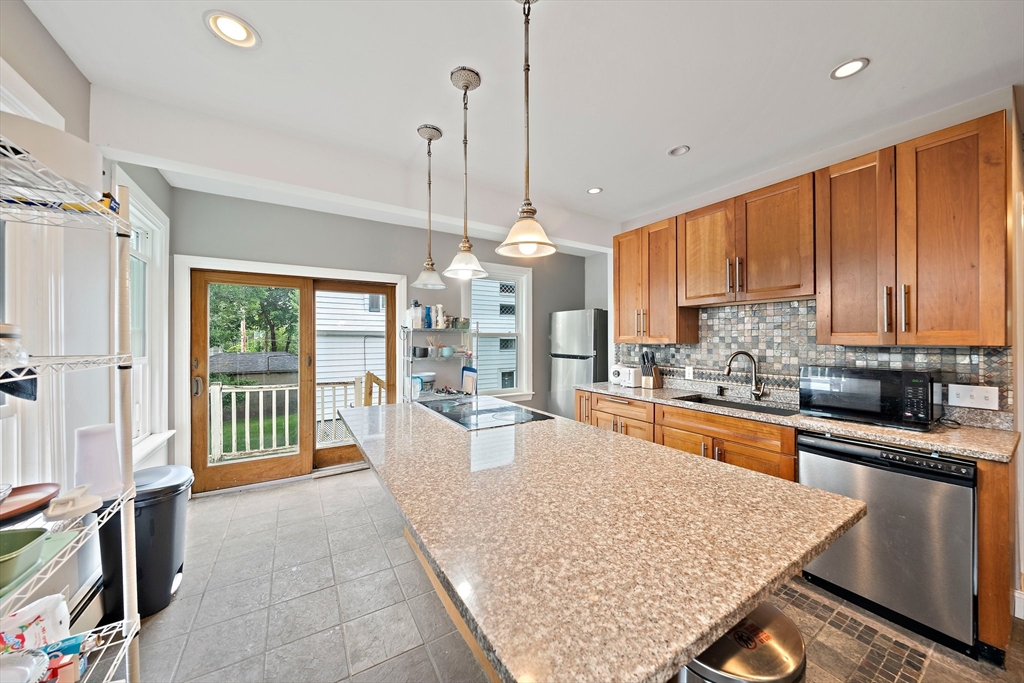 10 Trowbridge Road Worcester, MA 01609 - Photo 7 of 38 a large kitchen with kitchen island a large counter top stainless steel appliances and cabinets