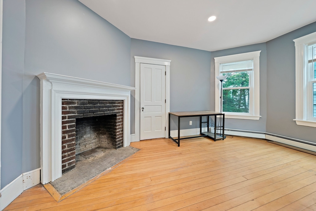 10 Trowbridge Road Worcester, MA 01609 - Photo 9 of 38 a view of an empty room with window and wooden floor