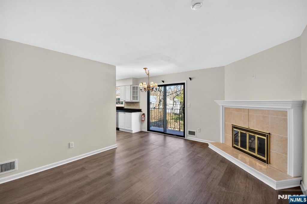 260 Prospect Street, Unit 12 Westfield, NJ 07090 - Photo 2 of 14 a view of a livingroom with wooden floor and a fireplace