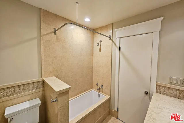 a bathroom with a tub and a shower