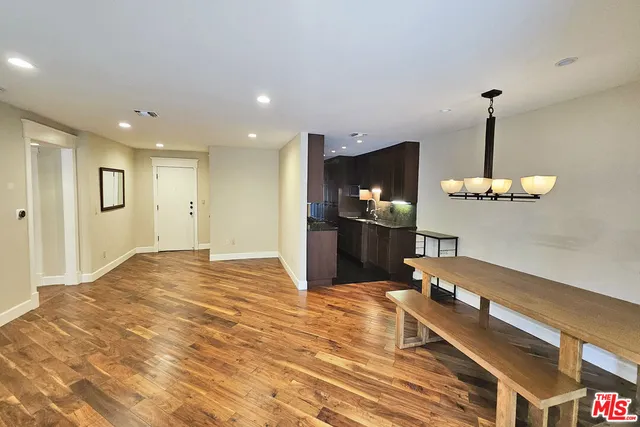 a living room with a table and a flat screen tv