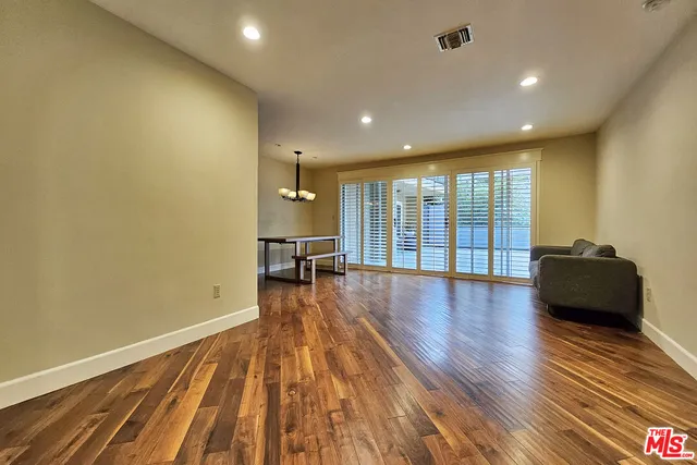 a living room with couch and a wooden floor