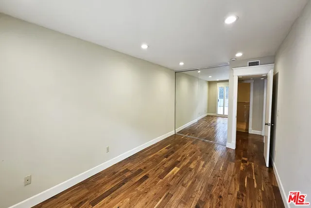 a view of hallway with wooden floor