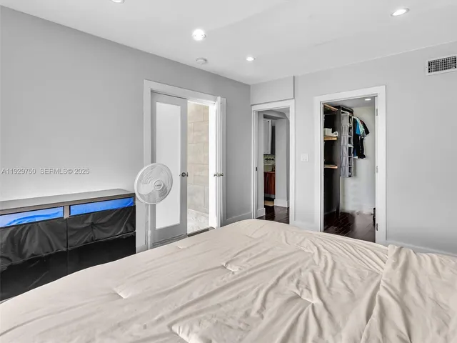 a bedroom with a bed and a mirror