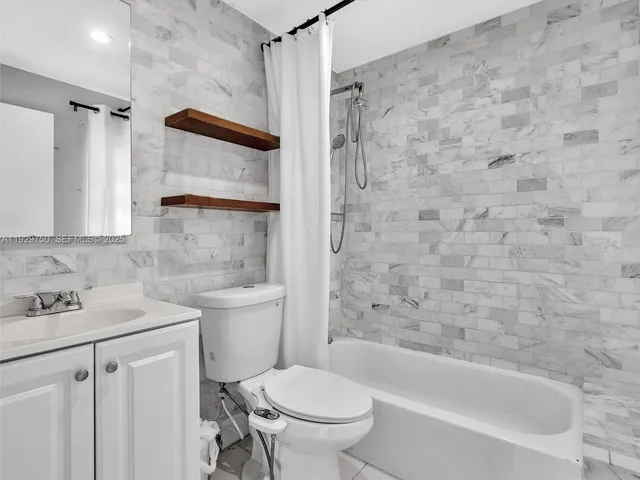 a bathroom with a toilet sink and shower