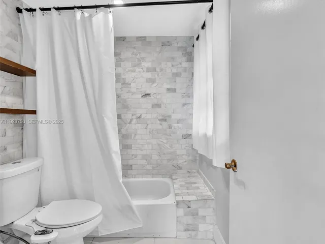 a bathroom with a shower and a toilet