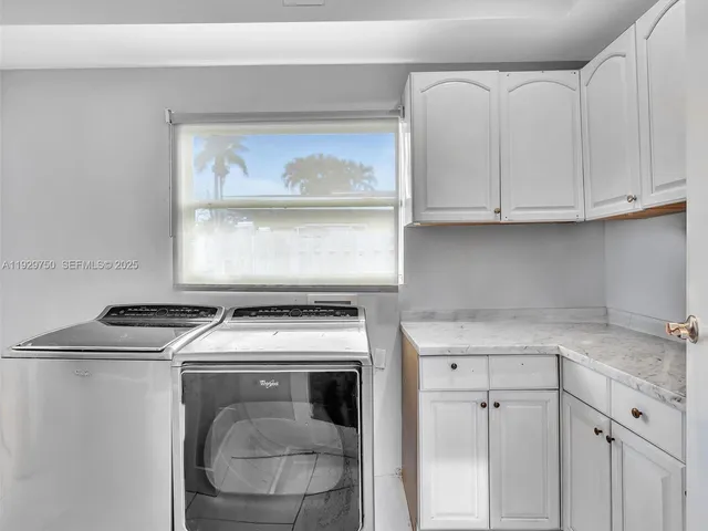 a kitchen with a stove top oven sink and cabinets