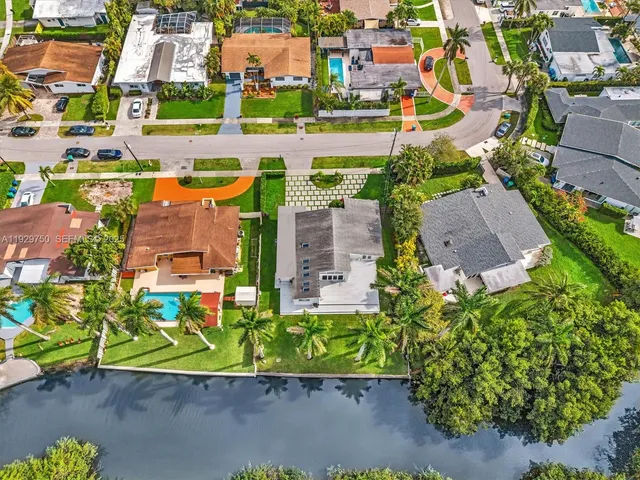 a view of house with yard and deck