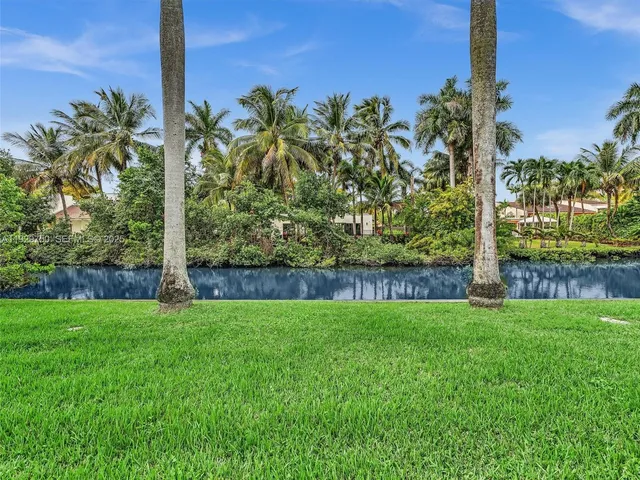 a view of a house with a big yard and potted plants