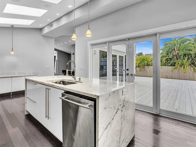 a kitchen with stainless steel appliances granite countertop a stove and a sink