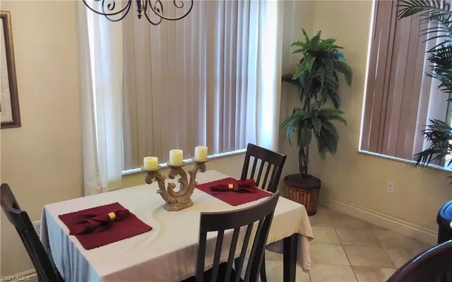 a view of a dining room with furniture and window