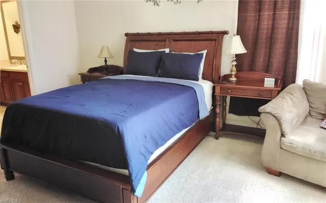 a bed sitting in a bedroom next to a window