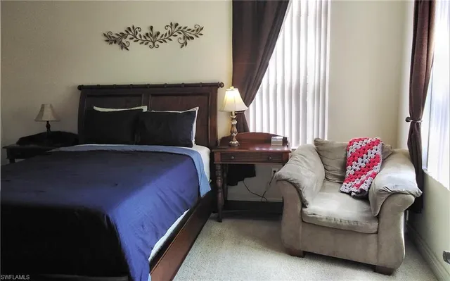 a bedroom with a bed and window